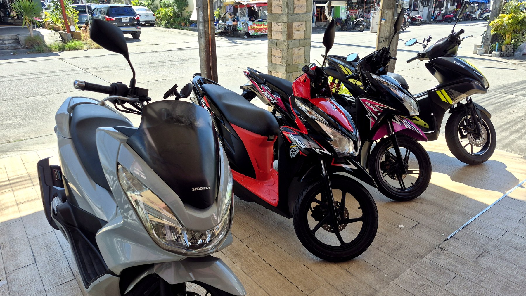 JV Rental Phuket motorbike fleet in front of the shop